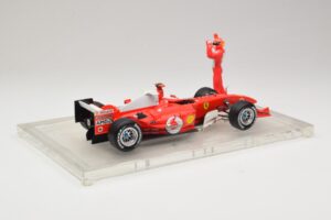 Ferrari F2004 #1 M. Schumacher F1 World Champion 2004 Z Dirkalnim Kombinezonom Hot Wheels 1:18 B66221 Kovina – slika 2 od 6